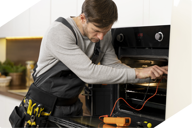 Professional technician repairing an oven, showcasing the benefits of choosing appliance repair over buying new ones.