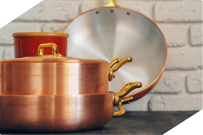 Elegant copper cookware set featuring shiny handles and polished finishes, perfect for gas stoves or gourmet kitchens.