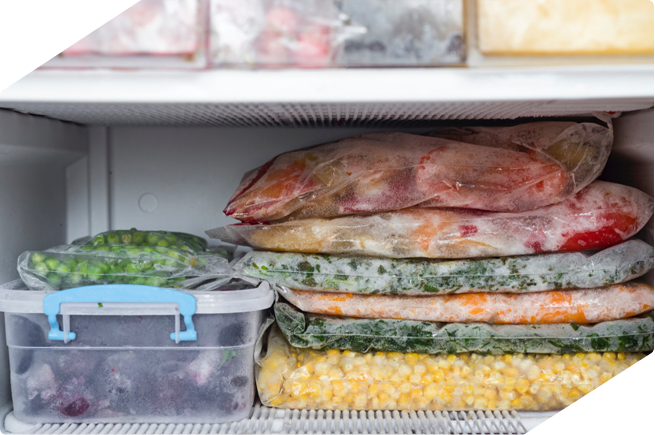 Frozen foods packed in bags and containers, perfectly organized in a freezer drawer for long-term storage.