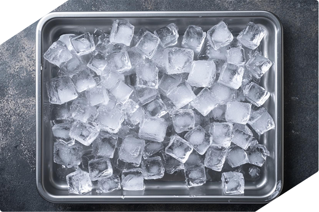 Close-up of ice cubes in a stainless steel tray, perfect for articles about KitchenAid refrigerator ice maker issues and trou