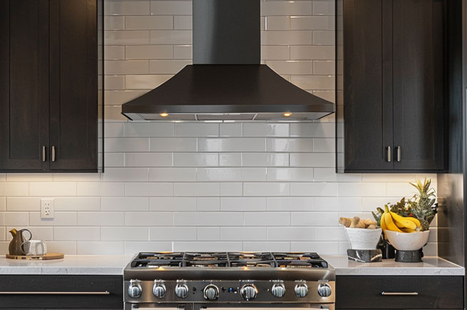 Sleek and stylish modern range hood over a gas stove, blending aesthetics with practical ventilation for a clean kitchen expe