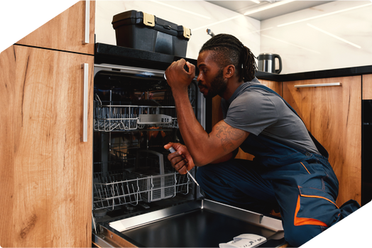 Technician inspecting and repairing a dishwasher, providing professional appliance repair service.